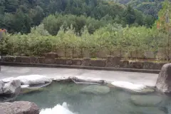 Stone-edged outdoor bath at Kojin no Yu in Tochio Onsen